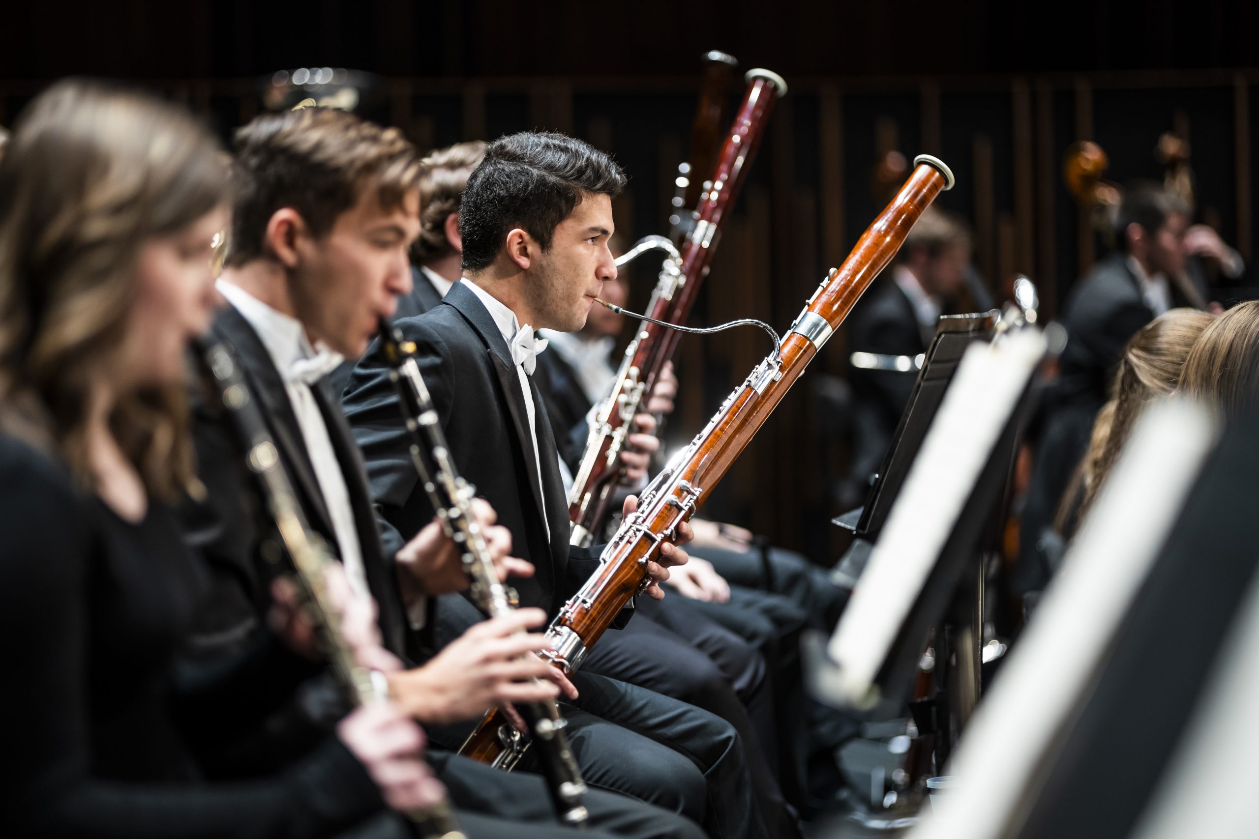 Wind section play from a side angle in concert