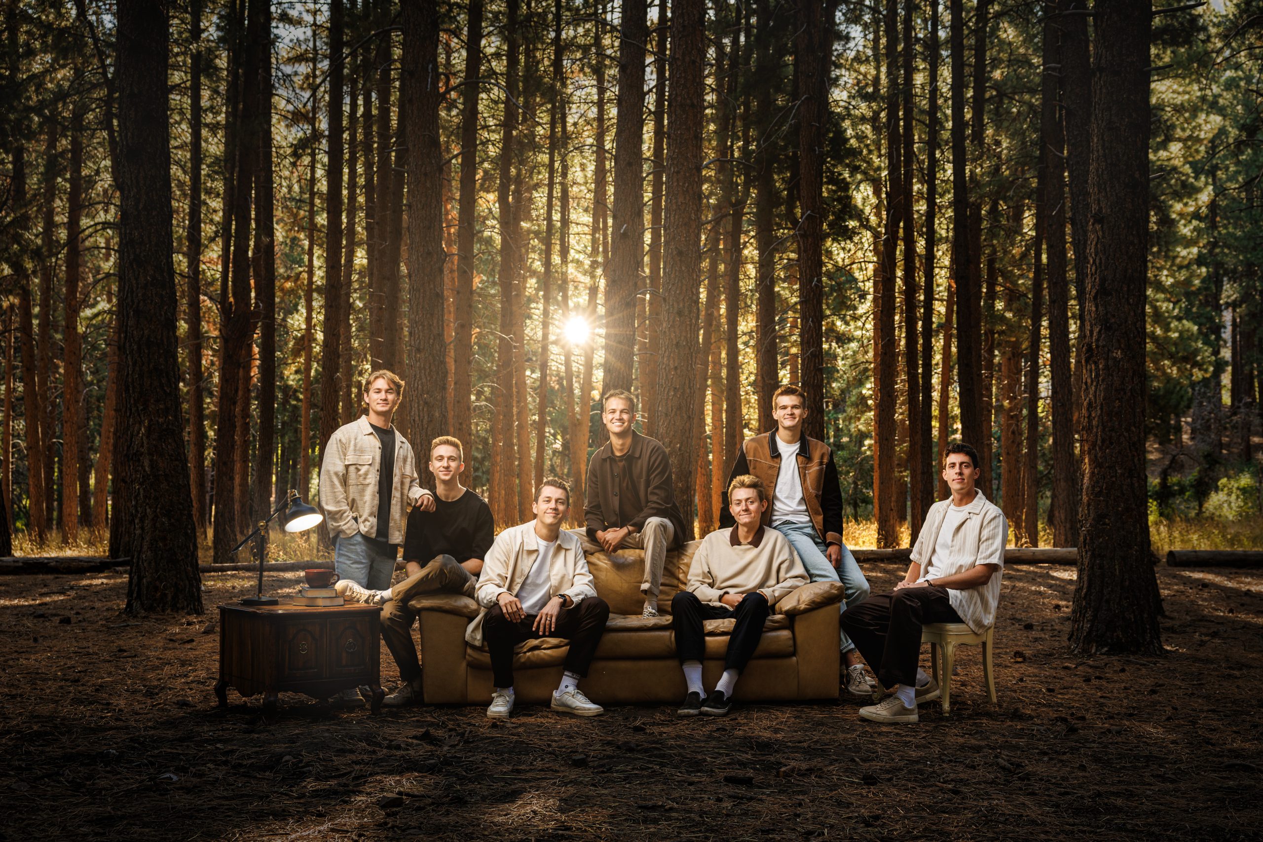 Vocal Point members sit in casual dress on a couch placed in Payson Canyon, Utah.