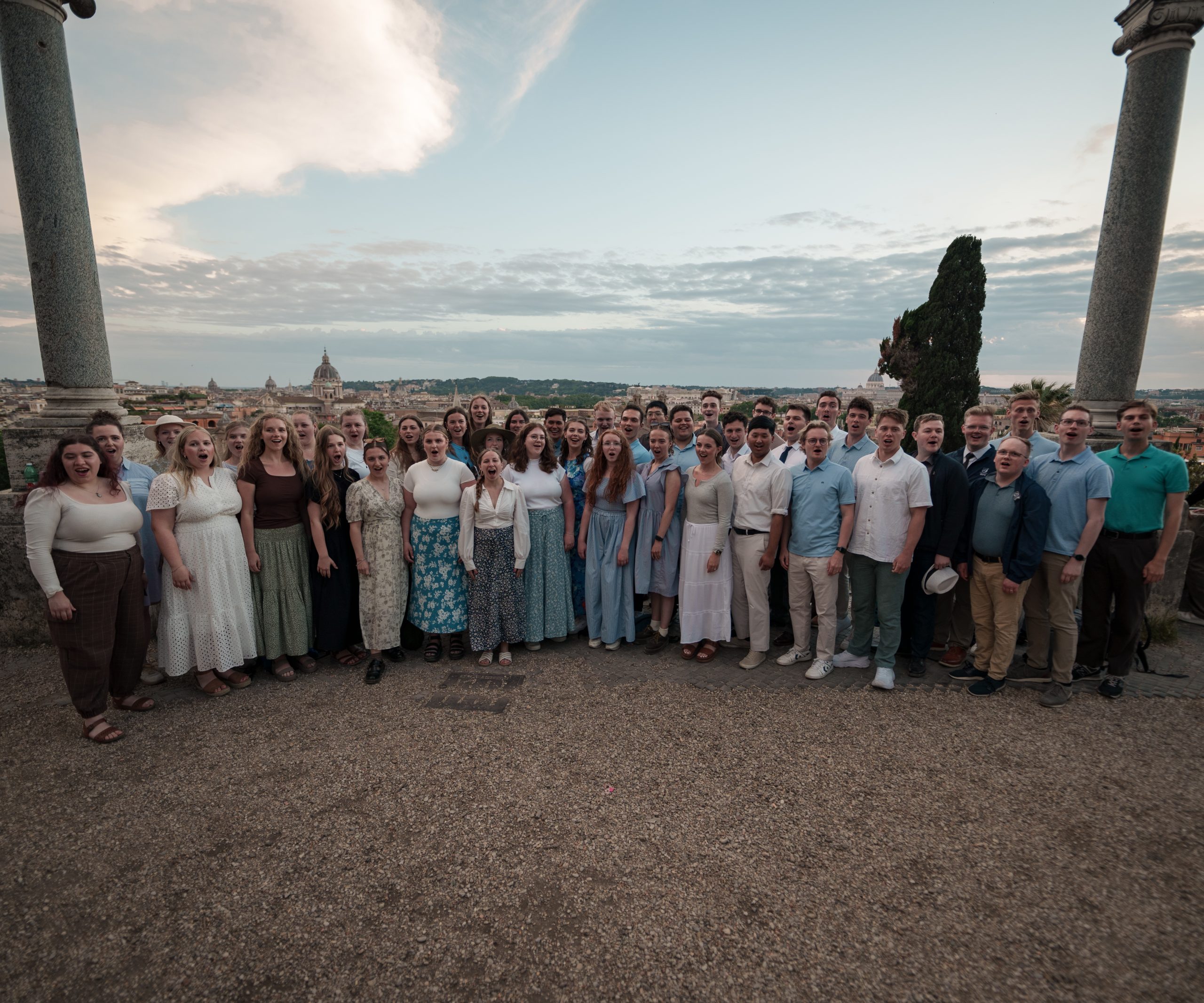 BYU Singers group photo taken outdoors with a beautiful view in their Europe extended tour