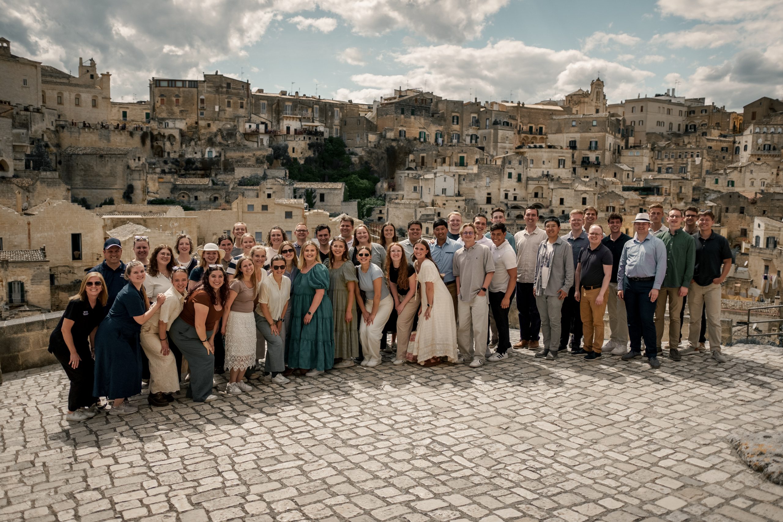 BYU Singers group photo taken outdoors with a beautiful view in Italy